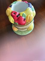 Top and side view showing fruit decorations and basket body