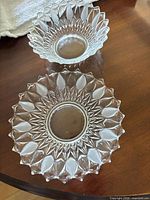 Top view of both pressed glass bowls showing starburst pattern