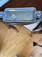 Top view of tray and two spreaders on wooden table