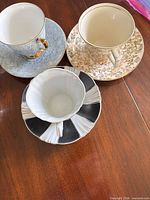 Three patterned teacups each on its corresponding saucer displayed on tabletop