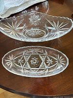 Top view of both clear pressed glass bowls showing starburst pattern and size