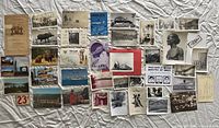 Overall layout showing all postcards, photos and ephemera
