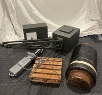 Group shot of crane prop, radio prop box, chains, wood pallet and wooden foundry form fragment