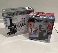 Front view of Smithsonian and Buki microscope kit boxes