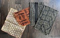Group shot of four fabric panels laid out on floor