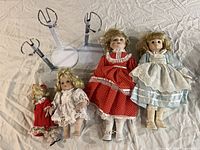 Group view of four dolls and three stands