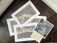Overview of five prints laid out on floor