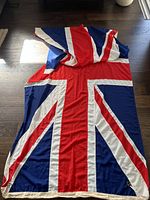 Union Jack cotton flag laid flat showing full design and grommet edge