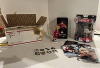 Full lot showing trading card box, bobblehead, sealed figure, photo stack, decal sheet