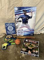Lot overview showing game box, bat, sign, poster, rackets, basketball