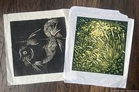 Both prints with tissue interleaves displayed on table