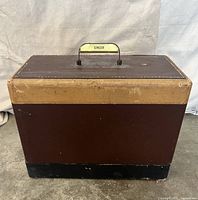 Brown two-tone Singer carrying case closed, handle visible