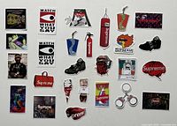 All stickers and keychain laid out on white background