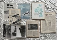 Overview of entire lot showing advertisements, articles and stacked photographs