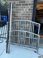 Headboard, footboard and rails leaned against wall