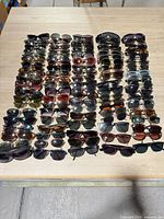 Front view of all sunglasses laid out in rows on tabletop