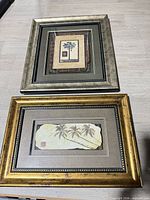 Front view showing both framed palm tree prints
