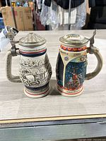 Both steins front view showing height and lid style