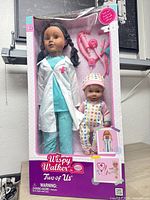 Front of sealed retail box showing both dolls and accessories