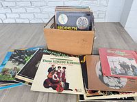 Box with stack of gospel LPs and several records spread out showing covers