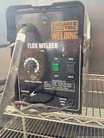 Front view showing Chicago Electric Welding branding, controls, specifications