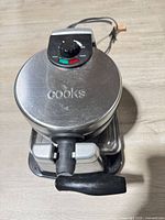 Overall view of waffle maker showing brand logo on lid and handle