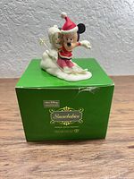 Figurine atop original box front view