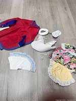 All seven dog costume pieces laid out on floor