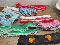 Group shot of seven assorted dog collar covers laid out on table