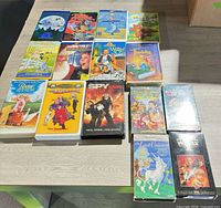 Tabletop view of all 18 VHS movies