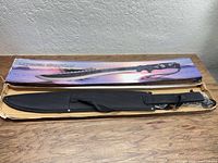 Sword in open box with sheath beside