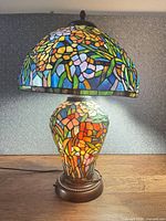 Front view of lit Tiffany-style stained glass lamp