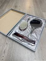Vanity set in box showing comb, brush, mirror