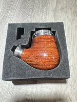 Side view of wood body and steel collar within foam insert