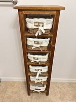 Front view of wood tower with six basket drawers inserted