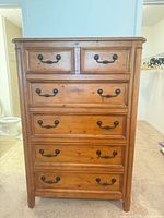 Front view showing seven drawers and hardware