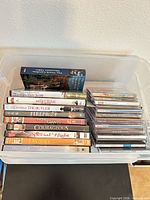 Overall view of plastic tote containing DVD and CD stacks