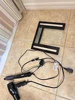 All three items laid out: glass digital scale, blow dryer, curling iron