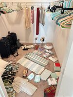 Closet floor view showing linens, hangers, mirrors, slippers