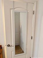 Mirror hanging on interior door, full view