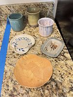 All six handmade stoneware pieces on counter