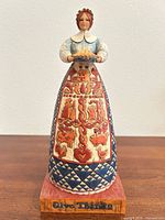 Full front view of pilgrim figurine on base