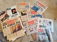 Spread of newspapers showing U.S. Storms Iraq, shuttle disaster, 1968 edition and JFK memorial items