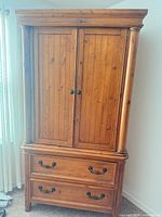 Front view of entire armoire showing doors and drawers