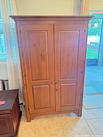 Front view closed showing paneled doors and crown moulding