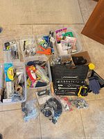Overview of all tubs with tools, hardware, rope, gloves, hacksaw and socket set