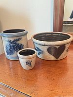 Three Rowe Pottery Works stoneware pieces grouped on table