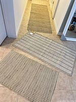 Three rugs laid out: runner, medium, small