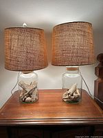 Both glass jar lamps side by side on table showing overall design