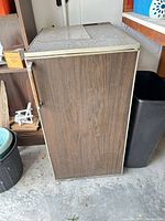 Front left view of closed refrigerator showing wood-grain exterior and handle